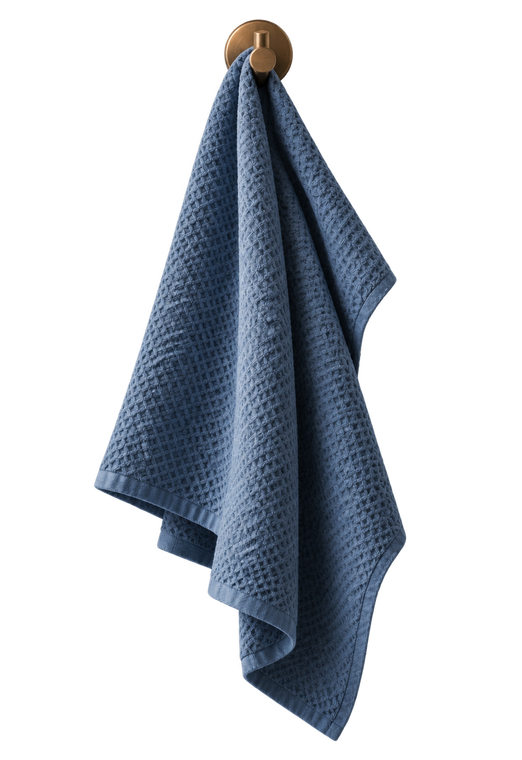Blue textured towel hanging on a round wall hook against a grey background.