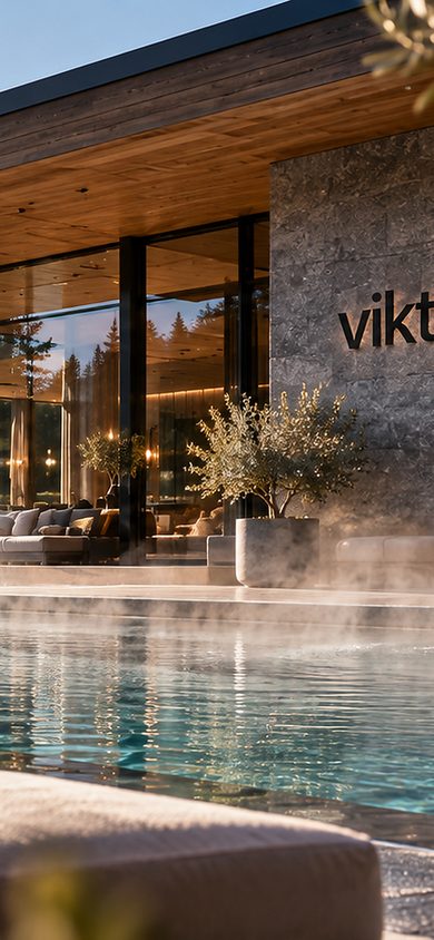 Heated outdoor pool with waterfall, terrace and mountain views in front of Hotel Viktoria.